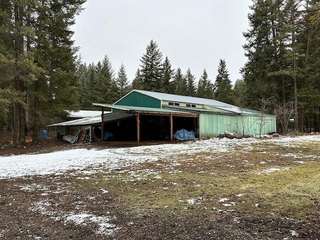 27 Birch Ln, Trout Creek, MT 59874 - snow covered structure with an outbuilding and a forest view