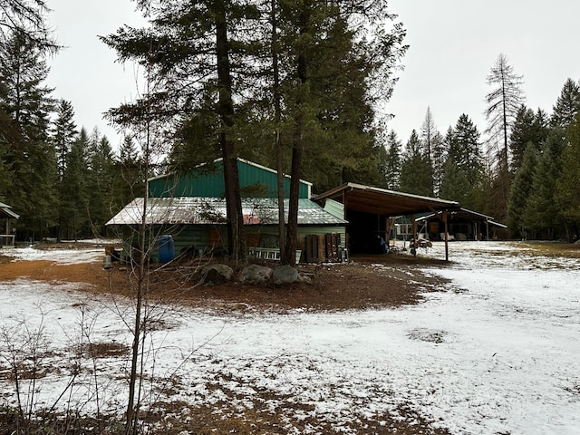 snow covered house with a carport