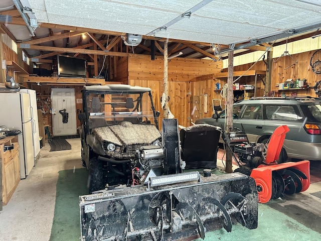 garage with white fridge and a garage door opener