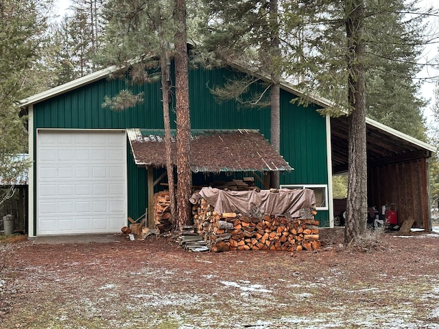 view of side of property with a garage and an outdoor structure