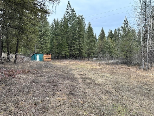 27 Birch Ln, Trout Creek, MT 59874 - view of yard with an outdoor structure and a forest view