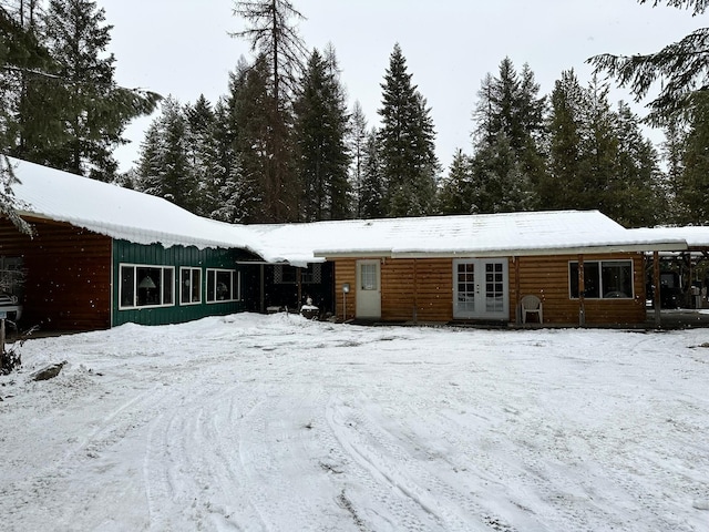27 Birch Ln, Trout Creek, MT 59874 - snow covered house with french doors