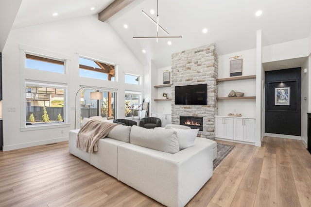 living room with built in shelves, high vaulted ceiling, beamed ceiling, a fireplace, and light hardwood / wood-style floors