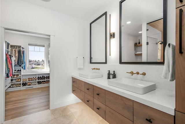 bathroom featuring tile patterned flooring and vanity