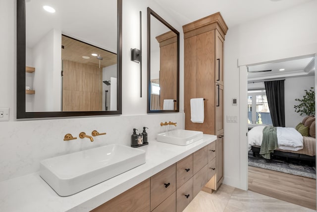 bathroom featuring vanity and tasteful backsplash