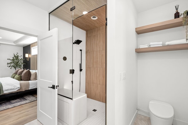 bathroom with hardwood / wood-style flooring, toilet, and walk in shower