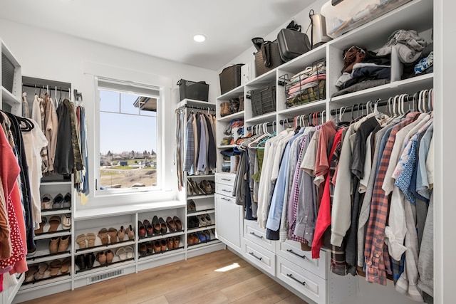 spacious closet with light hardwood / wood-style floors