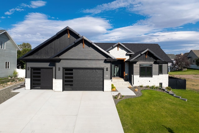 view of front of house with a garage and a front lawn