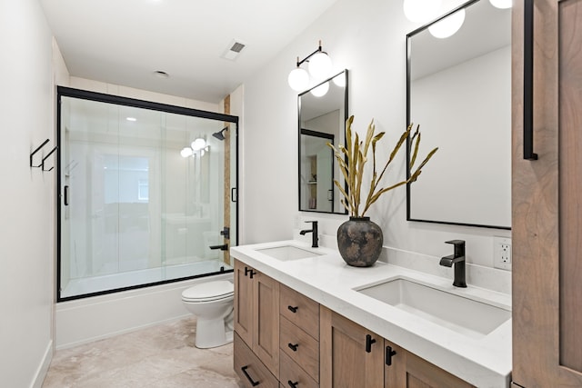 full bathroom featuring vanity, enclosed tub / shower combo, and toilet