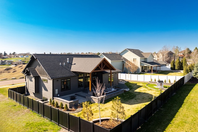 rear view of house with a yard and a patio area