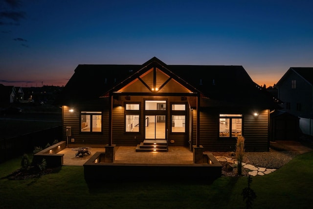 view of back house at dusk