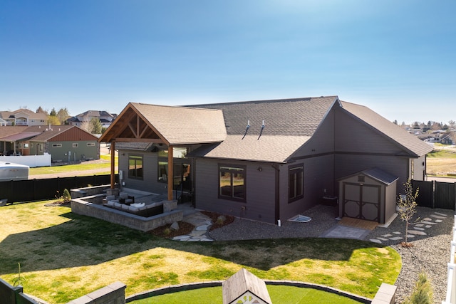 rear view of house featuring a yard, a patio, and a storage unit