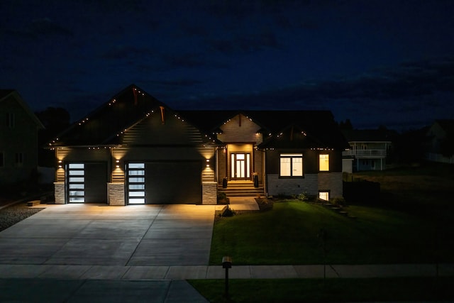 view of front of home featuring a lawn and a garage