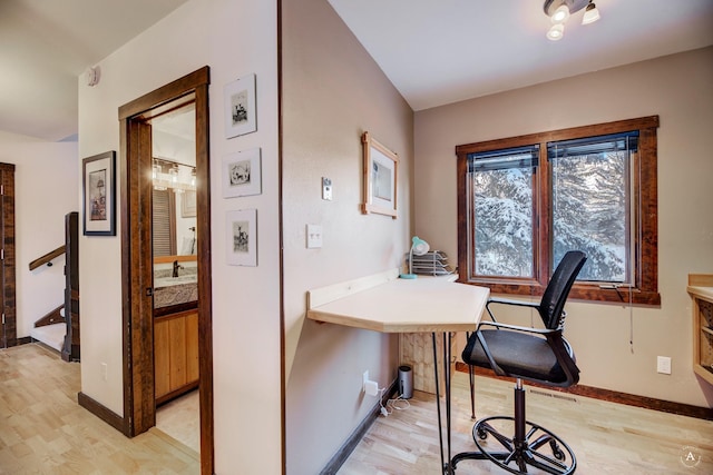 office with light wood-type flooring