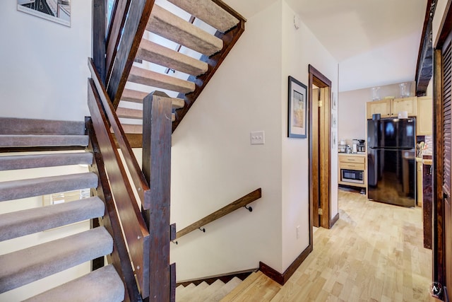 stairs with hardwood / wood-style floors