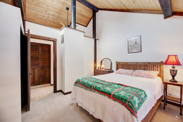 carpeted bedroom featuring lofted ceiling with beams and wood ceiling