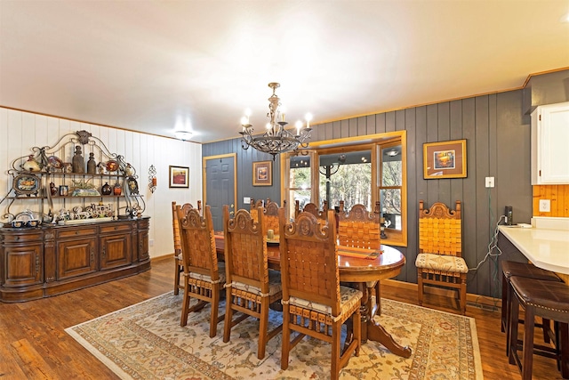 dining area with a notable chandelier and dark hardwood / wood-style floors