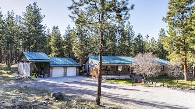 view of front of property with covered porch and a garage