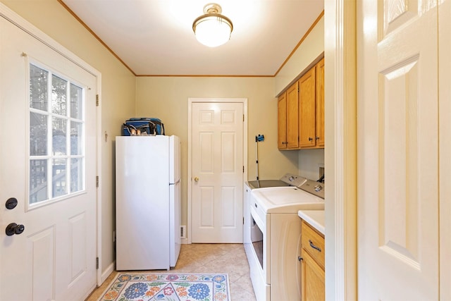 laundry area with washer and dryer, cabinets, light tile patterned floors, and crown molding