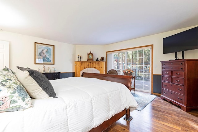 bedroom featuring wood-type flooring and access to outside