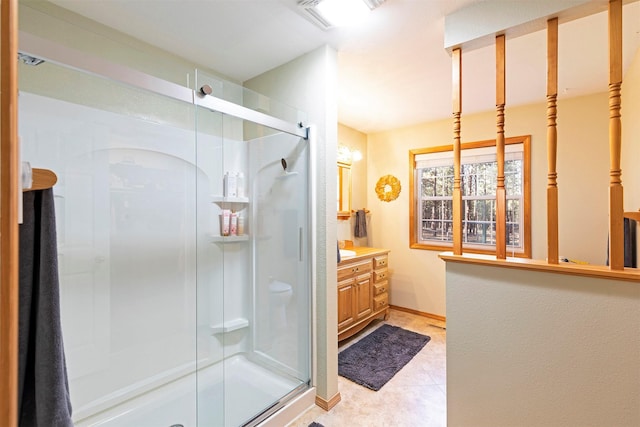 bathroom with tile patterned flooring, vanity, and walk in shower