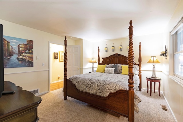 bedroom featuring light carpet