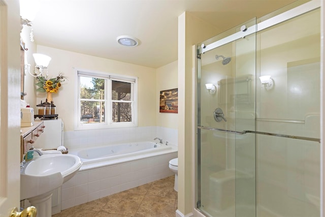 bathroom featuring tile patterned floors, toilet, and shower with separate bathtub