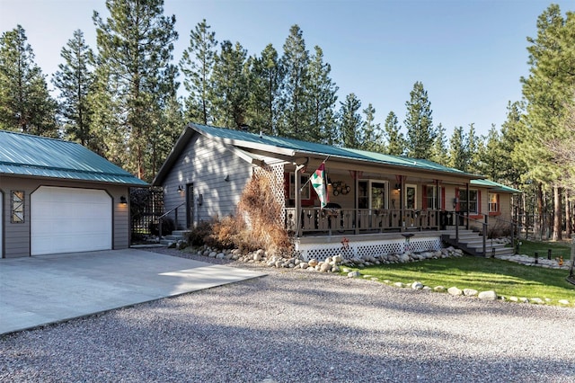 view of front of property featuring an outbuilding, covered porch, and a garage