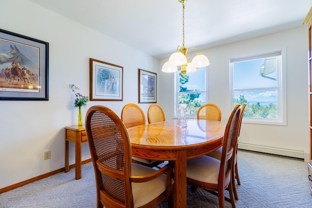 carpeted dining room with an inviting chandelier and a baseboard heating unit