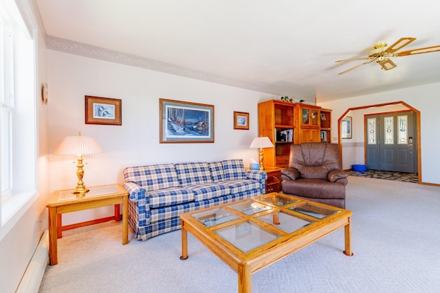 carpeted living room featuring ceiling fan