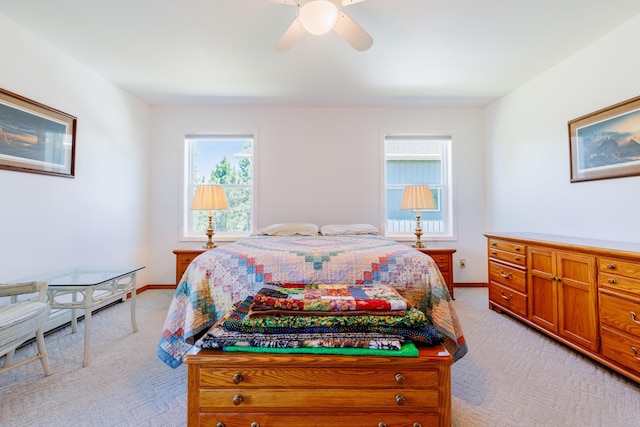 bedroom featuring ceiling fan and light carpet