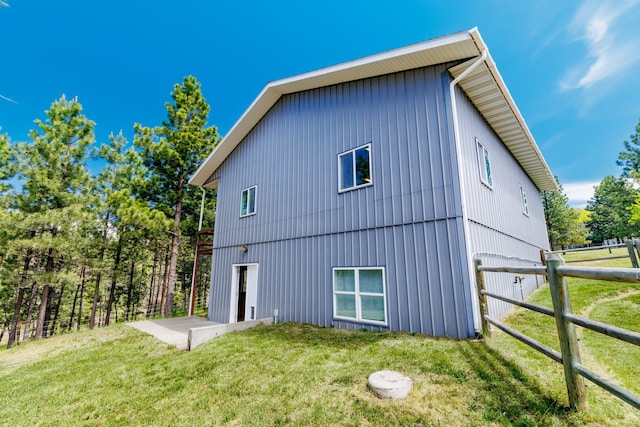 rear view of property with a lawn