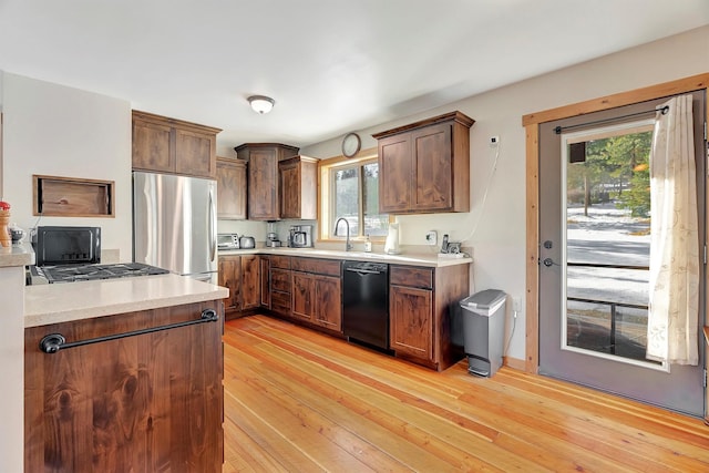 kitchen featuring sink, stainless steel appliances, and light hardwood / wood-style floors