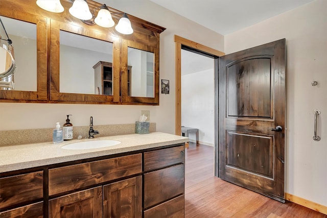 bathroom featuring hardwood / wood-style floors and vanity