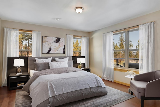 bedroom with dark wood-type flooring