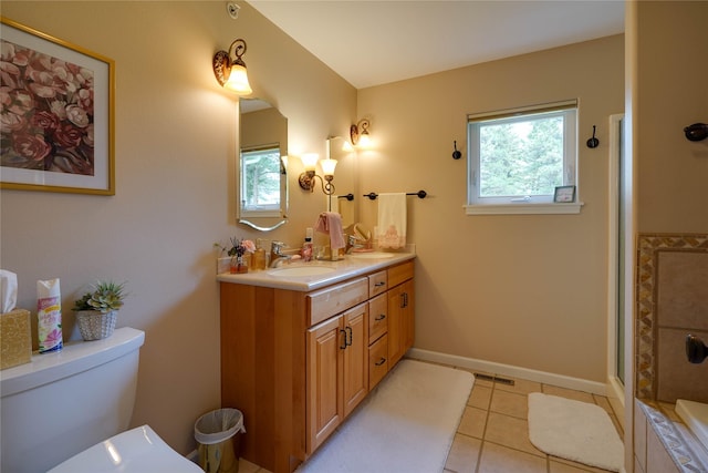 bathroom with tile patterned floors, vanity, a shower with shower door, and toilet