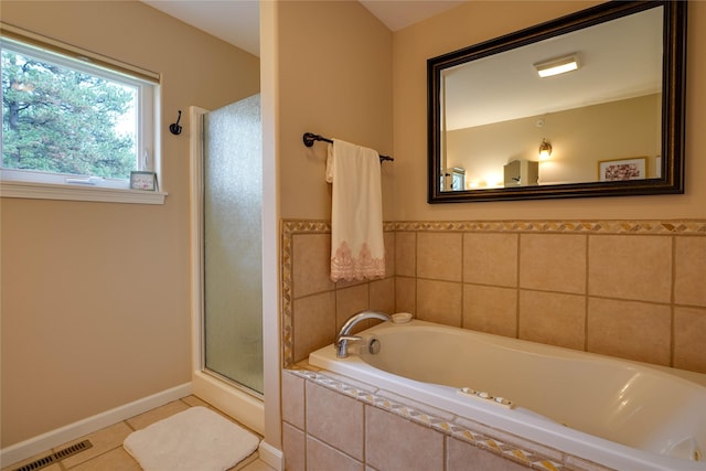 bathroom with tile patterned flooring and separate shower and tub