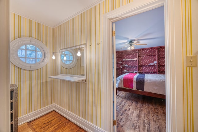 interior space featuring crown molding, ceiling fan, and wood-type flooring