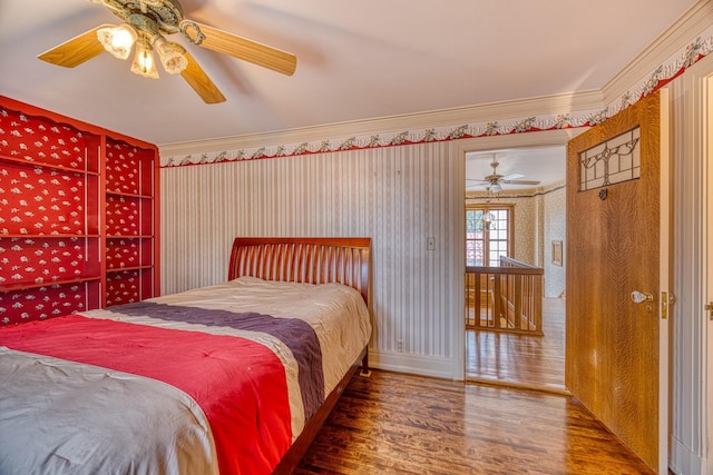 bedroom featuring hardwood / wood-style floors, ceiling fan, and ornamental molding