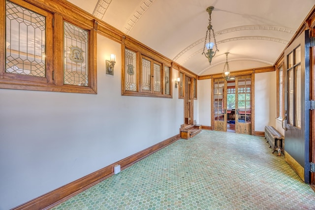 interior space featuring radiator heating unit, vaulted ceiling, and brick ceiling