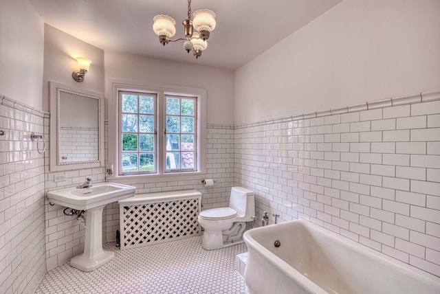 bathroom featuring tile patterned flooring, a bath, toilet, and tile walls