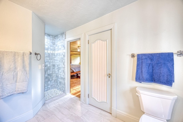 bathroom with toilet and a textured ceiling