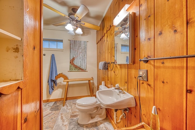 bathroom featuring ceiling fan, toilet, ornamental molding, and sink