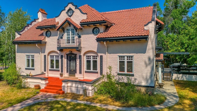 rear view of property with a balcony