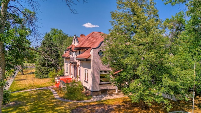 rear view of property featuring a lawn