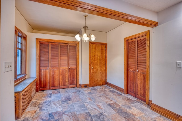 unfurnished bedroom with a notable chandelier