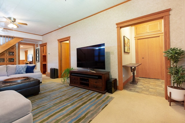 carpeted living room with ceiling fan and ornamental molding