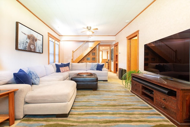 carpeted living room featuring ceiling fan and crown molding