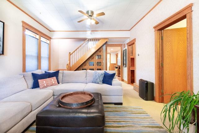 carpeted living room featuring ceiling fan and crown molding