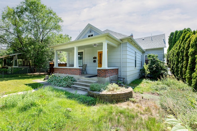 view of front of home featuring a front lawn and a porch